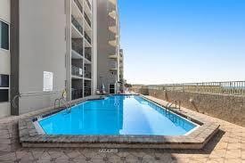 view of pool featuring fence