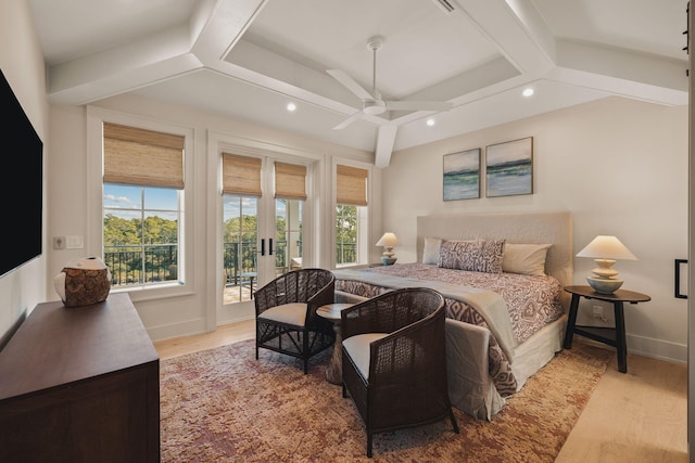 bedroom with beamed ceiling, wood finished floors, and access to exterior