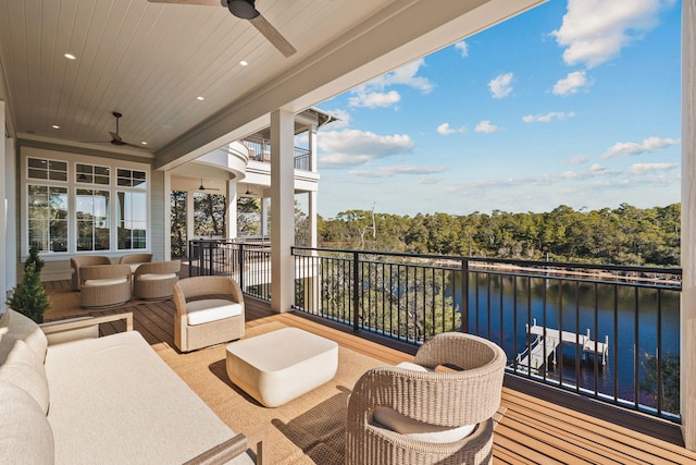 deck with an outdoor hangout area, a water view, and a ceiling fan