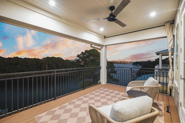 sunroom / solarium featuring a ceiling fan and wood ceiling