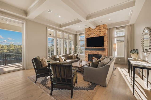 living room featuring a fireplace, light wood-style flooring, and beamed ceiling