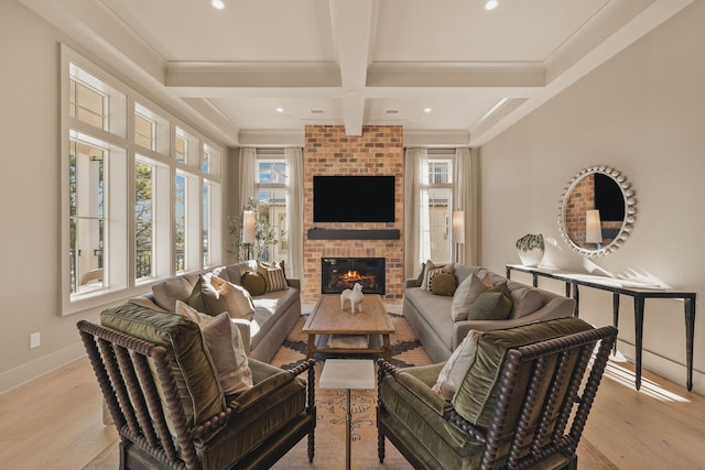 living area featuring baseboards, ornamental molding, beamed ceiling, and wood finished floors