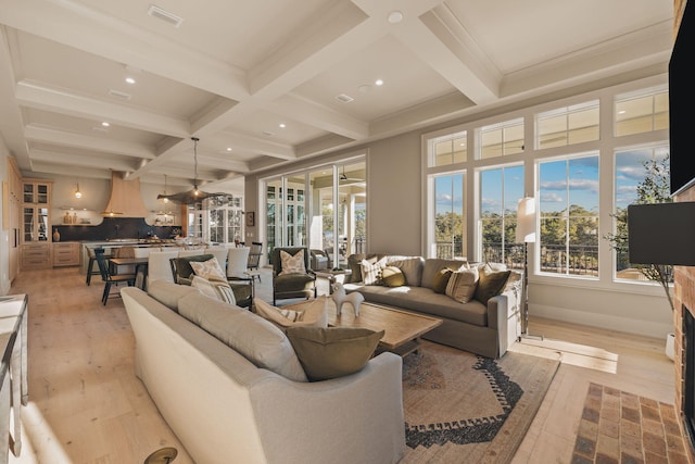 living room featuring beamed ceiling, coffered ceiling, light wood-style flooring, and recessed lighting