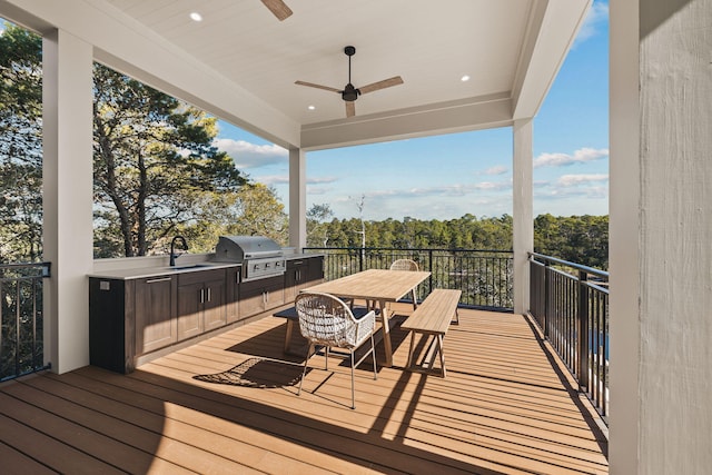 deck featuring a grill, ceiling fan, a sink, and area for grilling