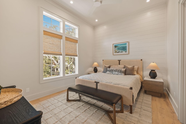 bedroom with baseboards, a ceiling fan, ornamental molding, light wood-style floors, and recessed lighting