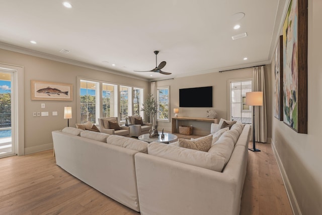 living room featuring recessed lighting, light wood-type flooring, visible vents, and crown molding