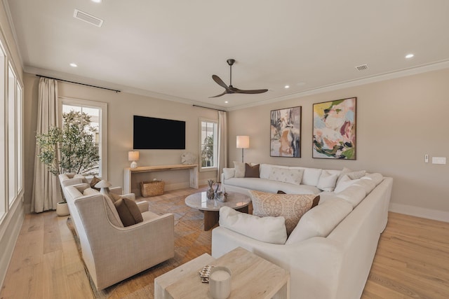 living room with a healthy amount of sunlight, light wood-style flooring, and visible vents