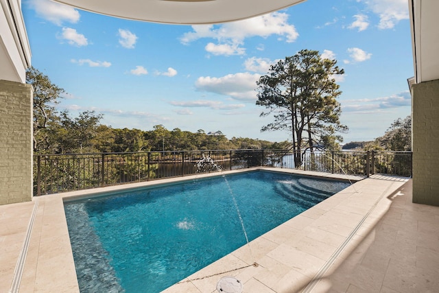 view of swimming pool with a fenced in pool and a patio area