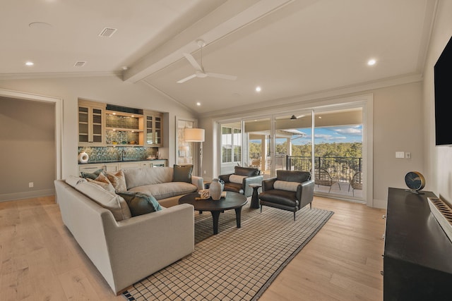 living room with vaulted ceiling with beams, ceiling fan, light wood-style flooring, baseboards, and ornamental molding