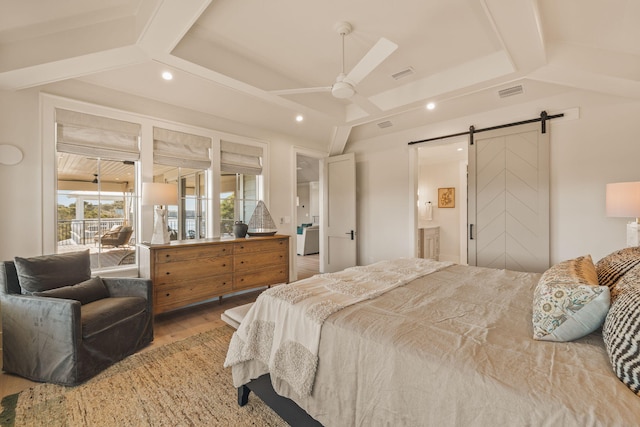 bedroom with a barn door, recessed lighting, wood finished floors, visible vents, and access to outside