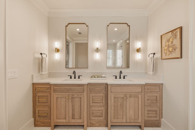 full bath with double vanity, crown molding, baseboards, and a sink