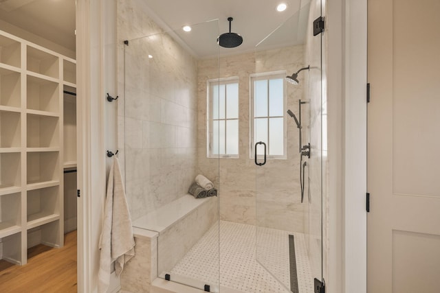 bathroom featuring wood finished floors, a shower stall, and recessed lighting