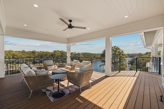 wooden deck with ceiling fan and an outdoor living space