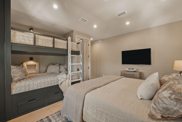 bedroom with wood finished floors, visible vents, and recessed lighting