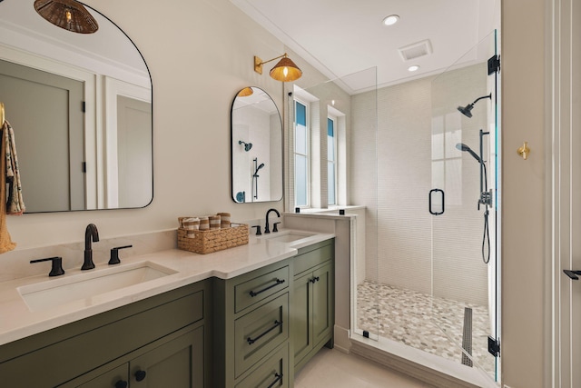 full bath with recessed lighting, a sink, a shower stall, and double vanity