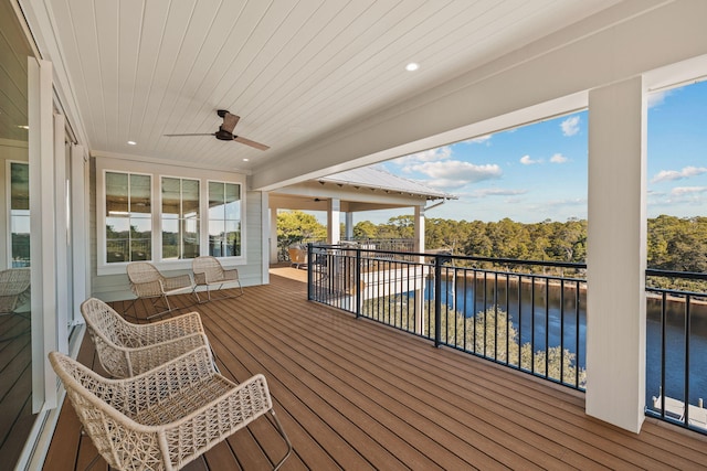 wooden deck featuring a water view and a ceiling fan