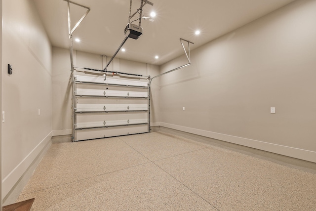 garage with a garage door opener, recessed lighting, and baseboards