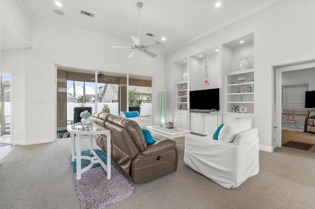 living area featuring light carpet, baseboards, built in shelves, and visible vents