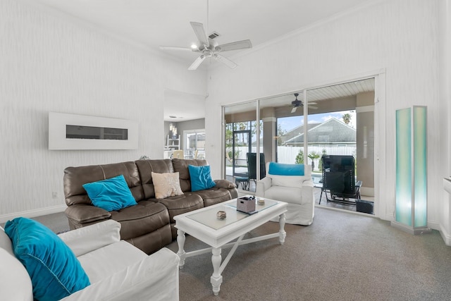 living room featuring carpet, crown molding, baseboards, and a ceiling fan