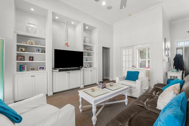 living area with built in shelves, recessed lighting, a ceiling fan, dark colored carpet, and crown molding