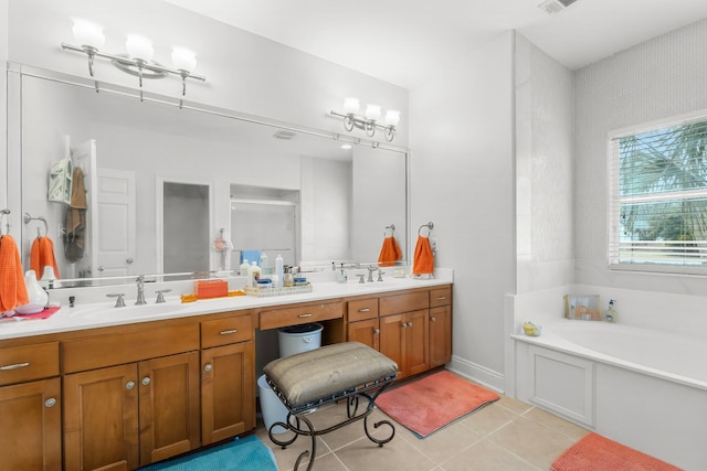 bathroom featuring tile patterned flooring, a garden tub, a sink, and double vanity