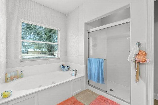 full bath featuring a stall shower, tile patterned flooring, and a bath