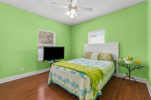 bedroom featuring a ceiling fan, dark wood-style flooring, and baseboards