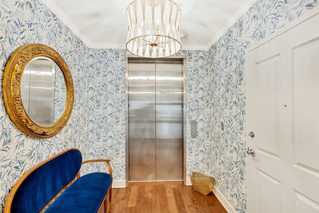 living area featuring wallpapered walls, elevator, crown molding, and wood finished floors