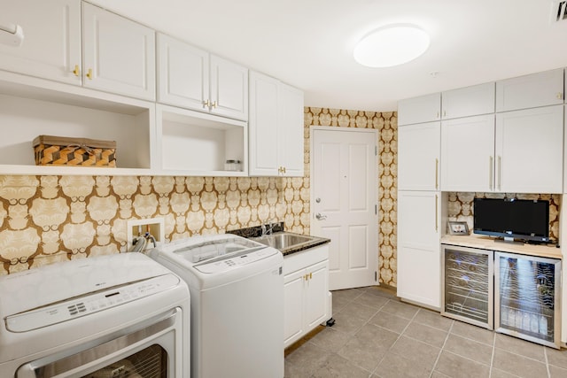 laundry area featuring cabinet space, visible vents, washer and clothes dryer, a sink, and light tile patterned flooring