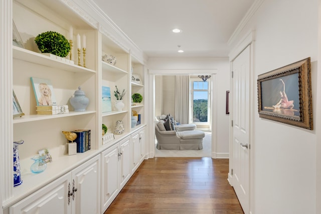 hallway featuring ornamental molding, recessed lighting, and dark wood finished floors