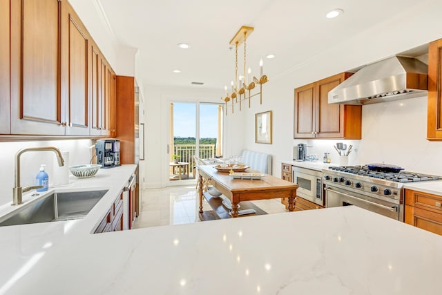 kitchen featuring stainless steel appliances, a sink, wall chimney exhaust hood, and ornamental molding