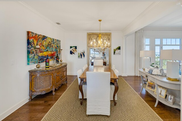 dining space with crown molding, visible vents, a chandelier, and dark wood-style flooring