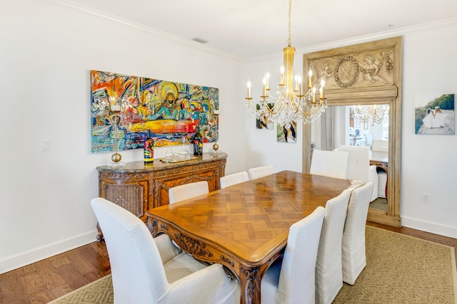 dining room with crown molding, baseboards, and wood finished floors