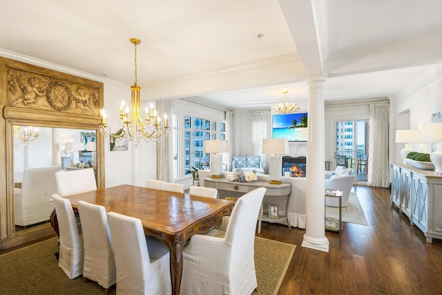 dining space featuring ornate columns, ornamental molding, dark wood-style flooring, and an inviting chandelier