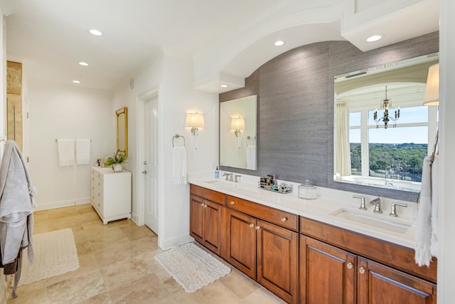 full bathroom with double vanity, baseboards, a sink, and recessed lighting