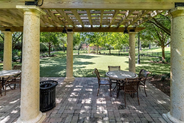 view of patio with outdoor dining area, fence, and a pergola