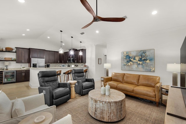846 Cannon Ln, Destin, FL 32541 - living area featuring beverage cooler, light wood finished floors, vaulted ceiling, and recessed lighting