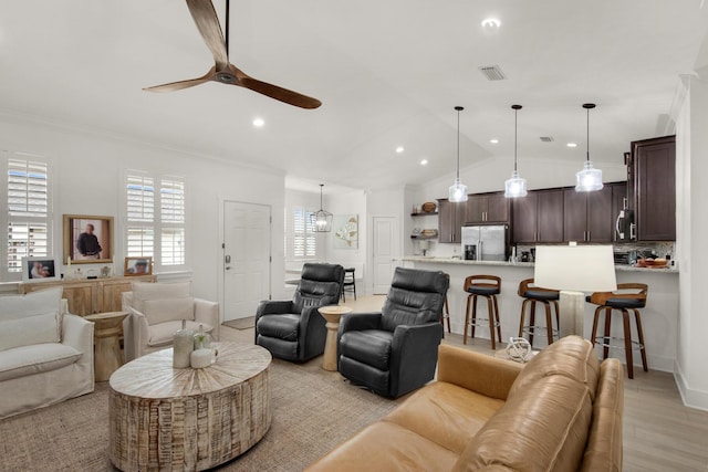846 Cannon Ln, Destin, FL 32541 - living room with light wood finished floors, visible vents, ornamental molding, vaulted ceiling, and ceiling fan