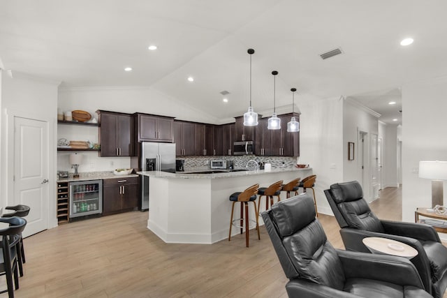 846 Cannon Ln, Destin, FL 32541 - kitchen featuring wine cooler, appliances with stainless steel finishes, open floor plan, dark brown cabinets, and pendant lighting