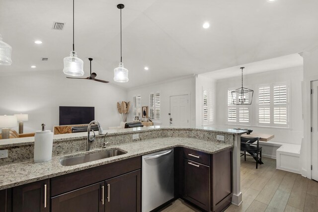 846 Cannon Ln, Destin, FL 32541 - kitchen with open floor plan, stainless steel dishwasher, a sink, and light stone counters