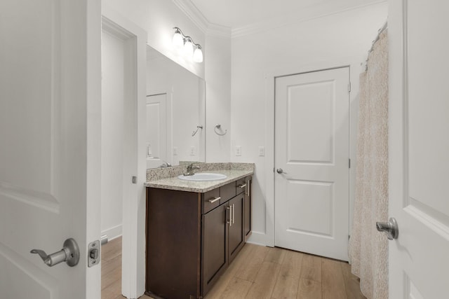 846 Cannon Ln, Destin, FL 32541 - bathroom featuring ornamental molding, vanity, and wood finished floors