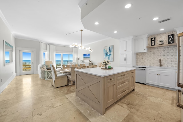 kitchen featuring visible vents, white cabinets, dishwasher, a center island, and light countertops