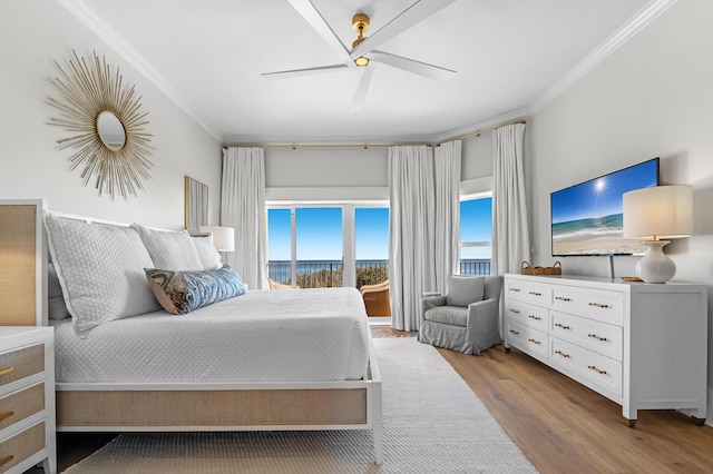 bedroom featuring ceiling fan, light wood-style flooring, and crown molding