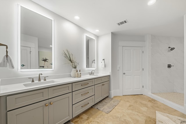 bathroom featuring a walk in shower, double vanity, a sink, and visible vents