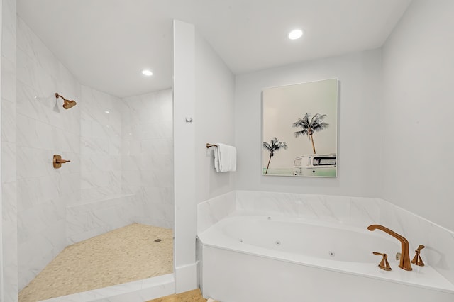 bathroom featuring a jetted tub, a tile shower, and recessed lighting