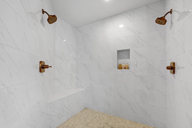 full bathroom featuring tiled shower