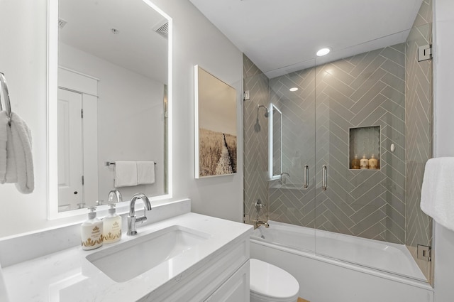 bathroom with visible vents, toilet, combined bath / shower with glass door, vanity, and recessed lighting