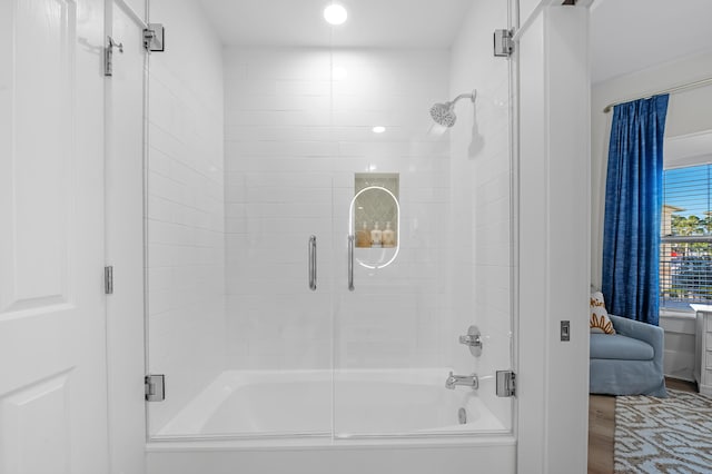 bathroom featuring shower / bath combination with glass door and wood finished floors