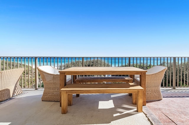 balcony featuring a water view and a beach view