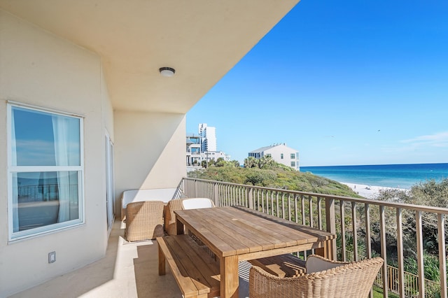 balcony featuring a water view and a view of the beach